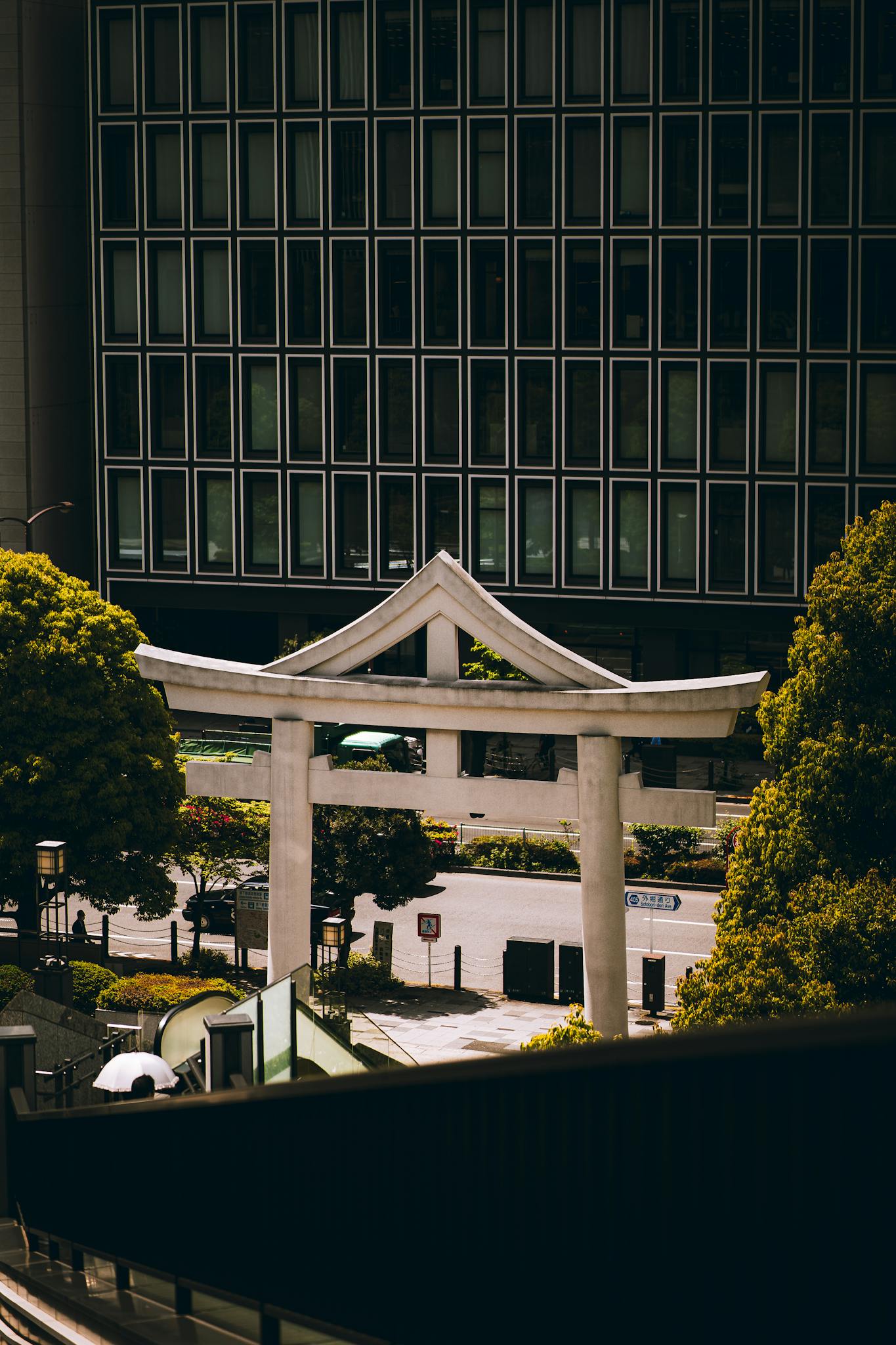 A beautiful torii gate amidst modern architecture in Tokyo, Japan.