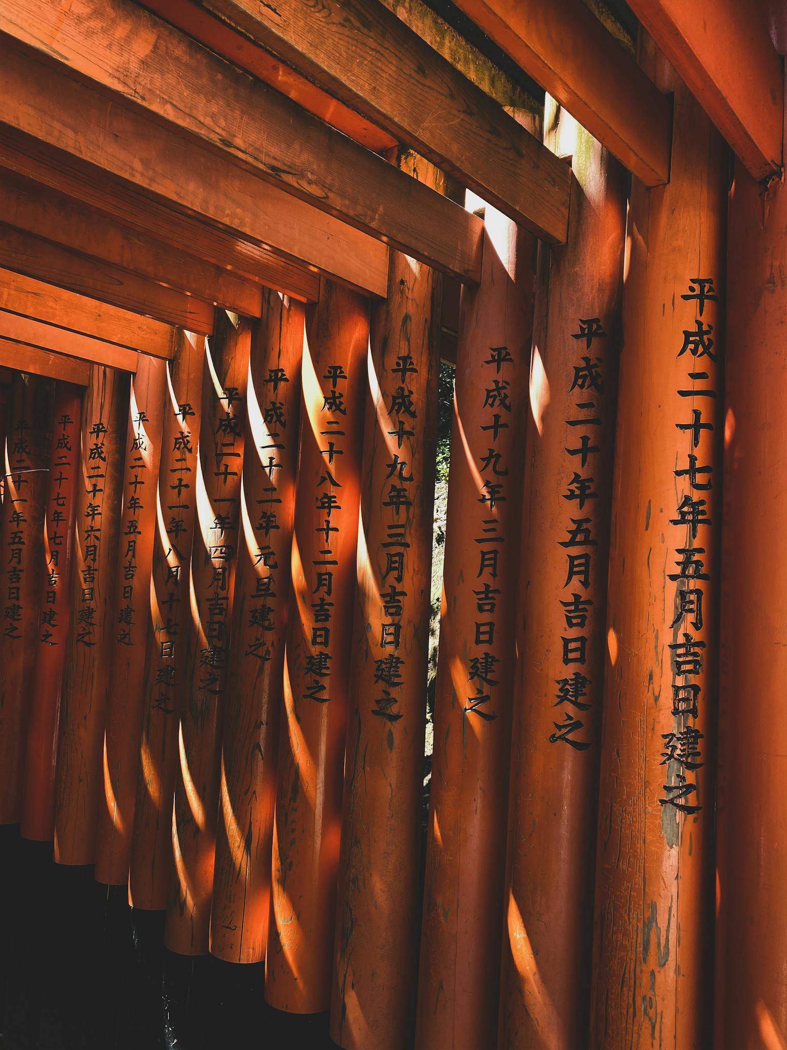 The vibrant orange Torii gates at the historic Fushimi Inari Shrine in Kyoto, Japan.